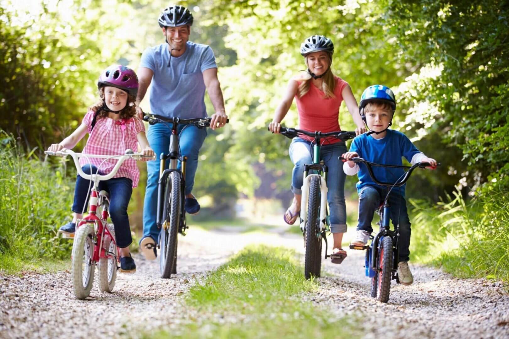 Family biking together on a sunny trail.